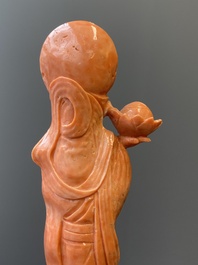 A Chinese red coral figure of a standing Bodhisattva with two dragons, 19/20th C.