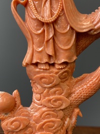 A Chinese red coral figure of a standing Bodhisattva with two dragons, 19/20th C.