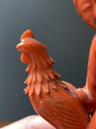 A Chinese red coral group of two ladies and a phoenix, 19/20th C.
