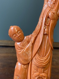 A Chinese red coral group of a standing Guanyin with a boy on a lotus flower, 19/20th C.