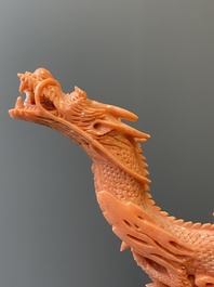 A Chinese red coral figure of a standing Bodhisattva with two dragons, 19/20th C.