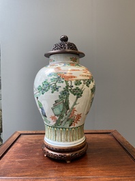 A Chinese famille verte vase with reticulated wooden cover and stand, Kangxi
