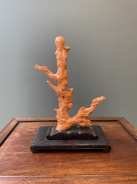 A Chinese red coral figure of a standing Bodhisattva with two dragons, 19/20th C.