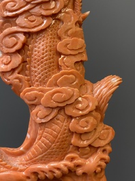 A Chinese red coral figure of a standing Bodhisattva with two dragons, 19/20th C.