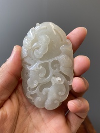 A Chinese white jade paper weight with a crane and a tiger, 17/18th C.