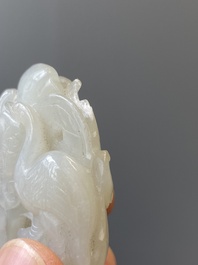 A Chinese white jade paper weight with a crane and a tiger, 17/18th C.