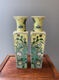 A pair of Chinese square yellow-ground famille verte vases, Kangxi mark, 19th C.