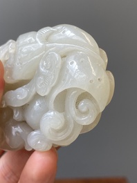 A Chinese white jade paper weight with a crane and a tiger, 17/18th C.