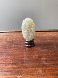 A Chinese white jade paper weight with a crane and a tiger, 17/18th C.