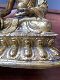A Sino-Tibetan gilt bronze Medicine Buddha or Bhaishajyaguru, 16th C.