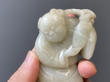 Two Chinese white and celadon jade carved standing boys, Qing