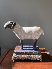 A Chinese cloisonn&eacute; model of a sheep standing on a rectangular base with Arabic inscription, Qing