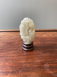A Chinese white jade paper weight with a crane and a tiger, 17/18th C.
