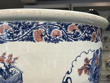 An exceptional massive Chinese blue, white and copper-red fish bowl with antiquities and 'Master of the rocks'-style panels, Kangxi