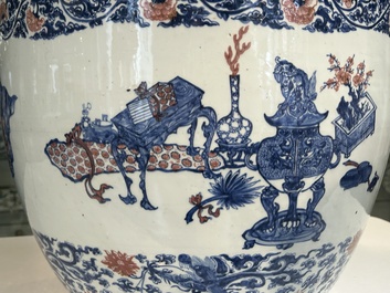 An exceptional massive Chinese blue, white and copper-red fish bowl with antiquities and 'Master of the rocks'-style panels, Kangxi