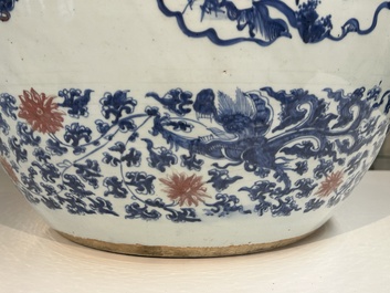 An exceptional massive Chinese blue, white and copper-red fish bowl with antiquities and 'Master of the rocks'-style panels, Kangxi