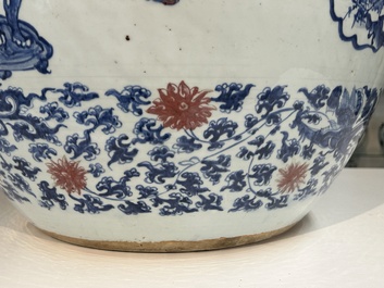 An exceptional massive Chinese blue, white and copper-red fish bowl with antiquities and 'Master of the rocks'-style panels, Kangxi