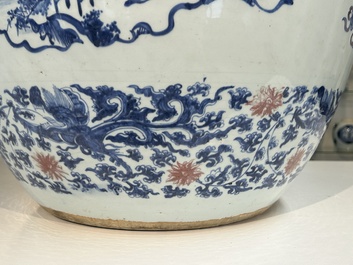 An exceptional massive Chinese blue, white and copper-red fish bowl with antiquities and 'Master of the rocks'-style panels, Kangxi