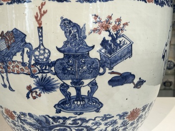 An exceptional massive Chinese blue, white and copper-red fish bowl with antiquities and 'Master of the rocks'-style panels, Kangxi