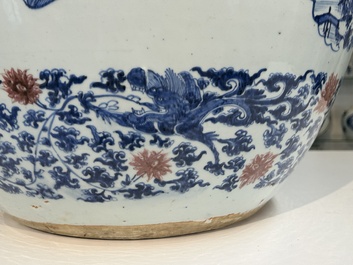 An exceptional massive Chinese blue, white and copper-red fish bowl with antiquities and 'Master of the rocks'-style panels, Kangxi