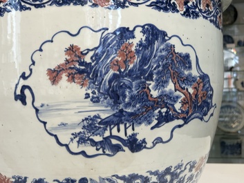 An exceptional massive Chinese blue, white and copper-red fish bowl with antiquities and 'Master of the rocks'-style panels, Kangxi