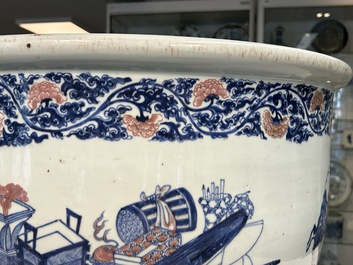 An exceptional massive Chinese blue, white and copper-red fish bowl with antiquities and 'Master of the rocks'-style panels, Kangxi