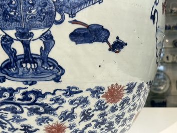 An exceptional massive Chinese blue, white and copper-red fish bowl with antiquities and 'Master of the rocks'-style panels, Kangxi