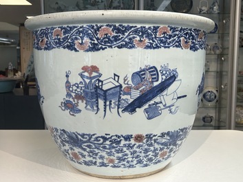 An exceptional massive Chinese blue, white and copper-red fish bowl with antiquities and 'Master of the rocks'-style panels, Kangxi