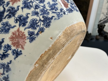 An exceptional massive Chinese blue, white and copper-red fish bowl with antiquities and 'Master of the rocks'-style panels, Kangxi