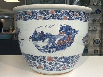 An exceptional massive Chinese blue, white and copper-red fish bowl with antiquities and 'Master of the rocks'-style panels, Kangxi