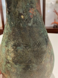 A rare archaic Chinese bronze gourd-shaped vase and cover, 'hu', Eastern Zhou