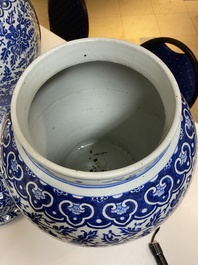 A pair of large Chinese blue and white 'lotus scroll' vases and covers, 19th C.