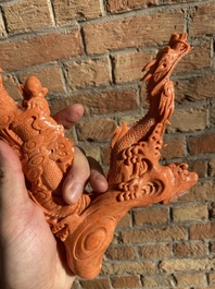 A Chinese red coral figure of a standing Bodhisattva with two dragons, 19/20th C.