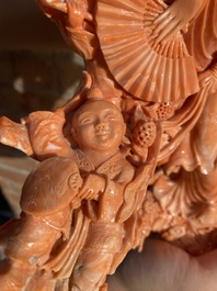 A large Chinese red coral group of a lady holding a cornucopia surrounded by children, 19/20th C.