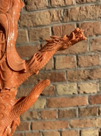 A Chinese red coral figure of a standing Bodhisattva with two dragons, 19/20th C.