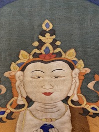 A Chinese kesi silk weaving depicting 'Buddha sitting on a lotus throne', Qing