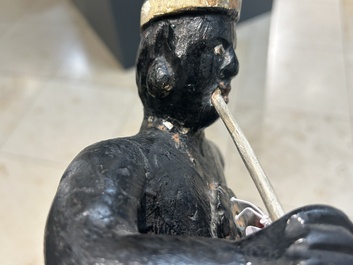 An English polychromed wood sculpture of a pipe-smoking Indian from a tobacco store, 18th C.