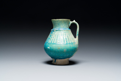 A turquoise-glazed jug, Kashan, Persia, 13th C.