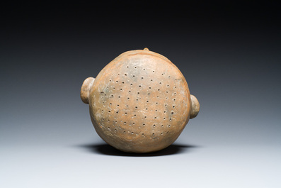 A terracotta lid fragment in the shape of a head, Southeast Asia, probably 19th C.