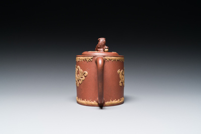 A Chinese Yixing stoneware teapot and cover with an applied dragon, Kangxi