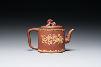 A Chinese Yixing stoneware teapot and cover with an applied dragon, Kangxi