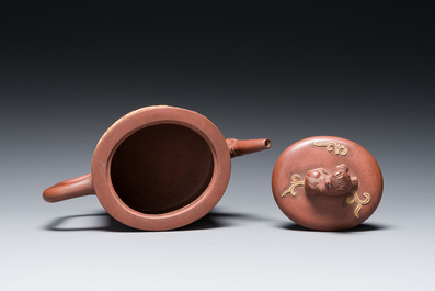 A Chinese Yixing stoneware teapot and cover with an applied dragon, Kangxi