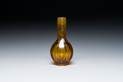 A Chinese facetted translucent green-coloured Peking glass bottle vase, Qianlong mark, 19th C.