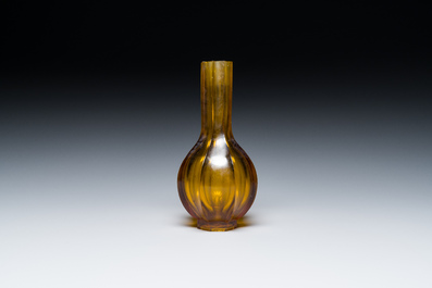 A Chinese facetted translucent green-coloured Peking glass bottle vase, Qianlong mark, 19th C.