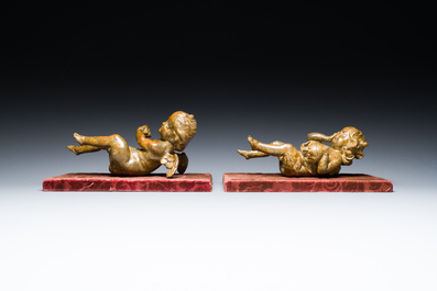 A pair of Flemish allegorical carved wood angels holding a Vanitas skull (Death) and a shell-shaped bowl (Life), 17th C.