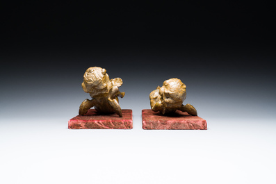 A pair of Flemish allegorical carved wood angels holding a Vanitas skull (Death) and a shell-shaped bowl (Life), 17th C.