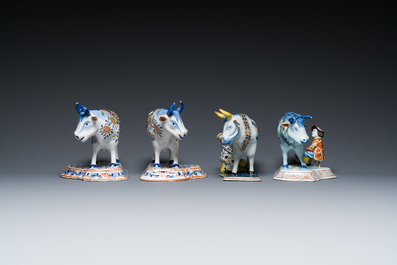 A pair of polychrome Dutch Delft cows and two 'milking' groups, 18/19th C.