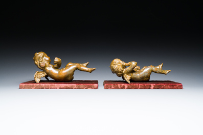 A pair of Flemish allegorical carved wood angels holding a Vanitas skull (Death) and a shell-shaped bowl (Life), 17th C.