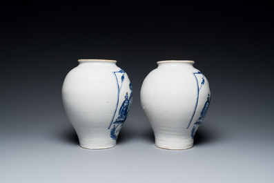 A pair of Dutch Delft blue and white tobacco jars with the royal British coat of arms, late 18th C.