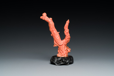 A Chinese red coral group of a lady and a boy, 19/20th C.